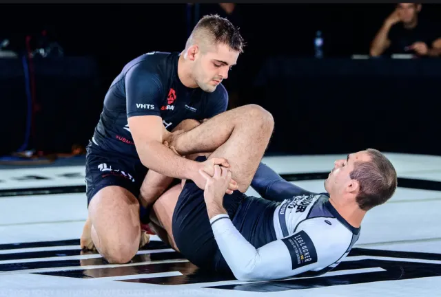 Grapplers training on the mat.