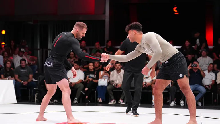 William Tackett and an opponent shake hands before a grappling match.