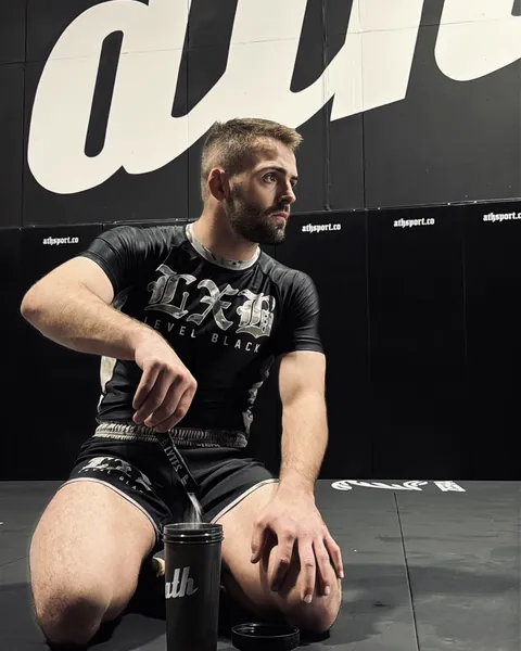 William Tackett seated on a training mat.